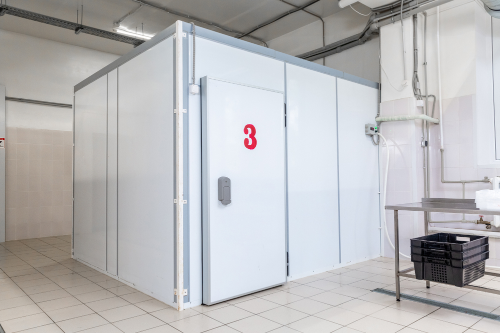 Industrial,Cooling,Chamber,Outside,View Large white walk-in cold room numbered 3 in industrial facility.