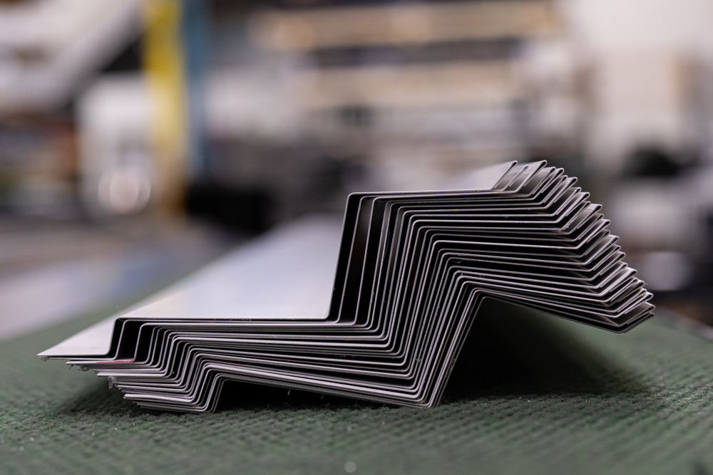 Metal,Flashing,In,A,Metal,Roofing,Factory,Workshop Stack of corrugated metal roofing sheets.